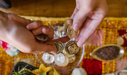 Akshaya Tritiya: gold coins and jewellery held over a puja plate