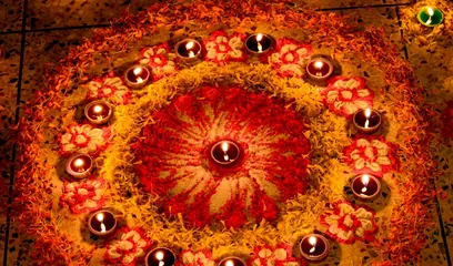 Diwali: diyas arranged in a circle on a flower rangoli