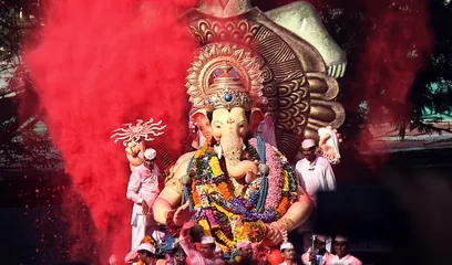 Ganesh Chaturthi: a crowned Ganesh idol amid red gulal