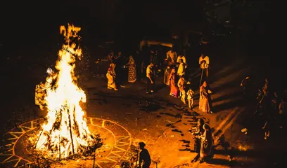 Holika Dahan: the Holika bonfire burning at night as people gather