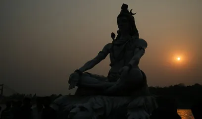 Maha Shivaratri: a statue of Shiva in meditation at dusk