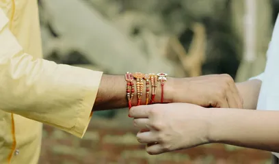 Raksha Bandhan: a sister tying a rakhi on her brother's wrist