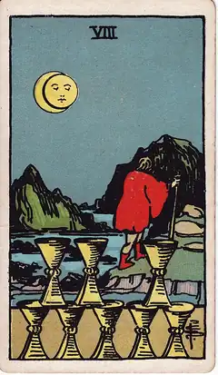 Eight of Cups. A cloaked man walks away over rocky ground towards mountains under an eclipsed moon, leaving eight cups stacked behind him.
