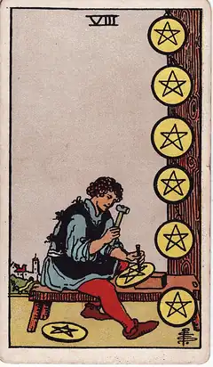 Eight of Pentacles. A craftsman at a bench hammers a pentacle into a disc, six already hung up beside him and one at his feet.