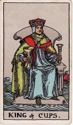King of Cups. A crowned king sits on a throne afloat on rough sea, a cup in one hand and a sceptre in the other, a fish leaping behind.