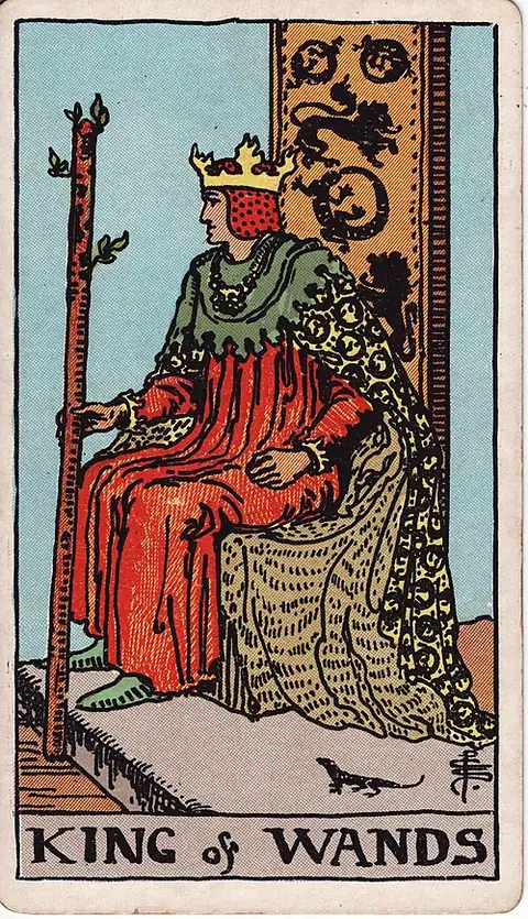 King of Wands. A crowned king sits in profile holding a sprouting staff, salamanders and lions on his throne and robe.