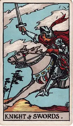 Knight of Swords. A knight charges flat out with sword raised, cloak and horse's mane streaming, trees bent in the wind.