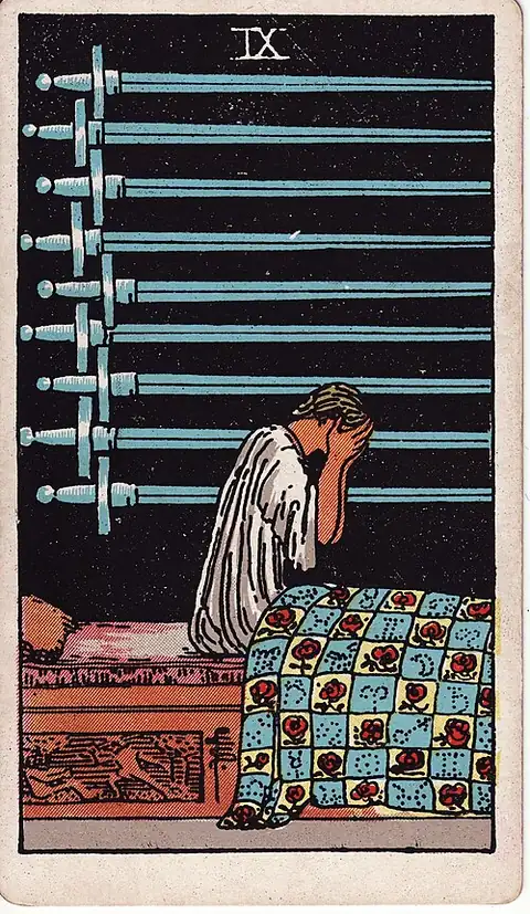 Nine of Swords. A figure sits up in bed with the face in both hands, nine swords hanging on the wall behind in the dark.