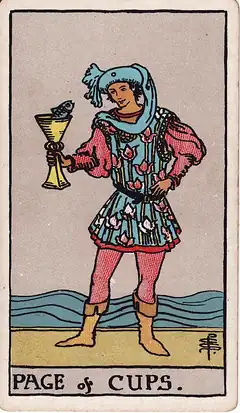 Page of Cups. A young figure in a flowered tunic holds up a cup with a fish looking out of it, the sea behind.