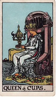 Queen of Cups. A crowned woman sits at the water's edge gazing into an ornate closed cup shaped like a shrine.