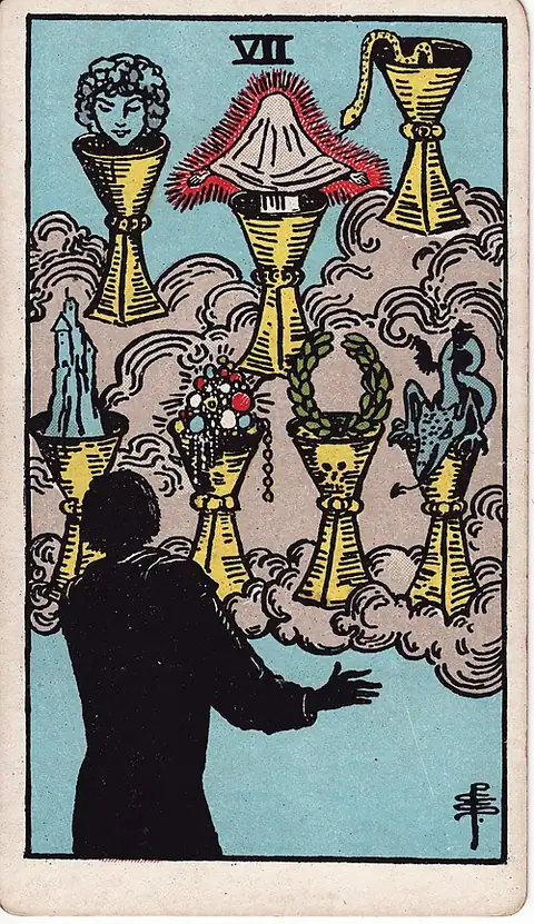 Seven of Cups. A dark figure faces seven cups in a cloud holding a face, a veiled figure, a snake, a castle, jewels, a wreath and a dragon.