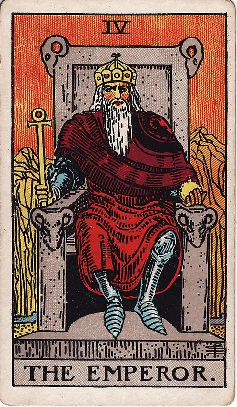 The Emperor. A bearded king sits square on a stone throne carved with rams' heads, holding an ankh sceptre, with bare red mountains behind him.