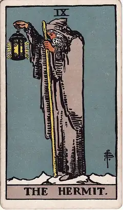 The Hermit. A grey-bearded man alone on a snowy peak holds up a lantern with a six-pointed star inside it, leaning on a long staff.