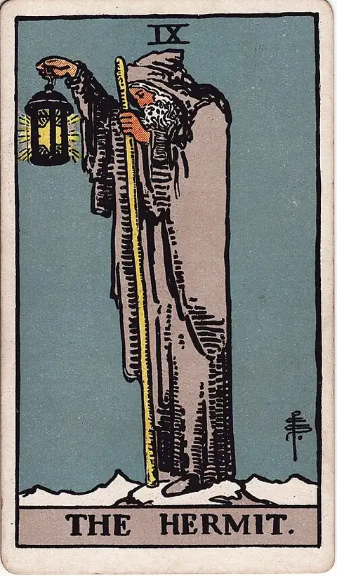 The Hermit. A grey-bearded man alone on a snowy peak holds up a lantern with a six-pointed star inside it, leaning on a long staff.