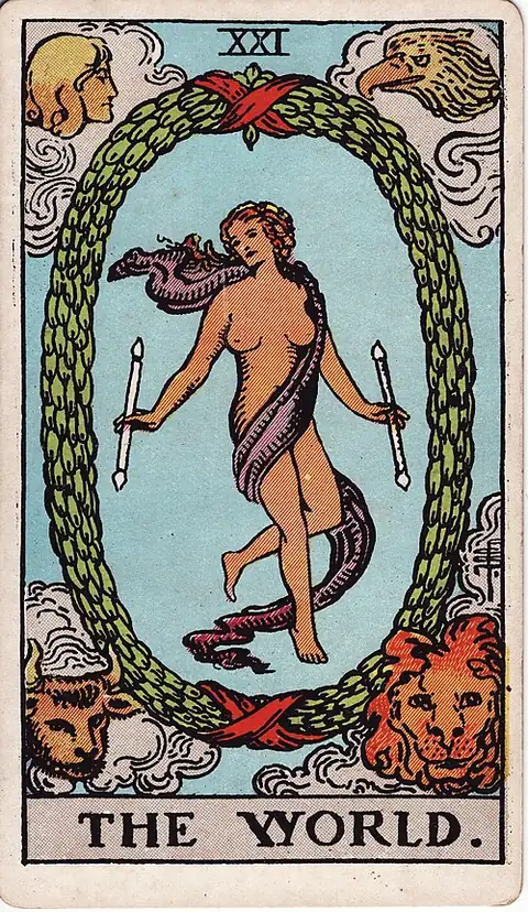The World reversed. A dancing figure wrapped in a violet scarf floats inside an oval wreath holding two wands, with the bull, lion, eagle and angel in the four corners.