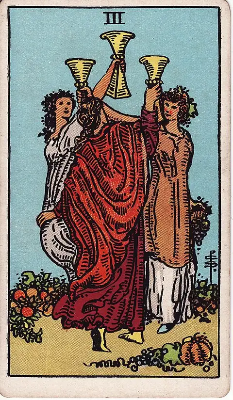 Three of Cups. Three women raise their cups together in a circle among vines and fruit.